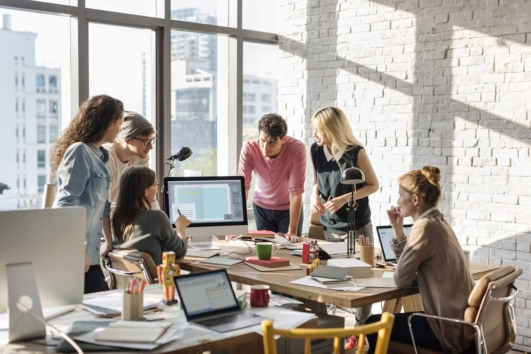 Six people holding a meeting together